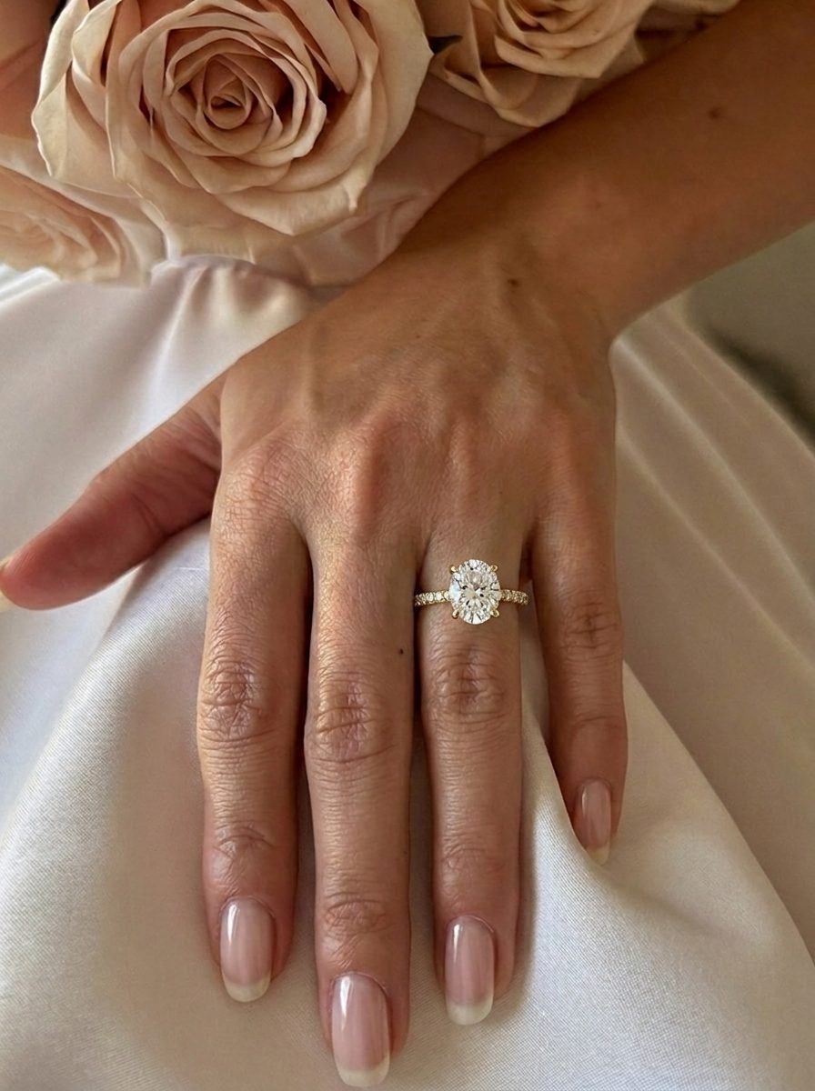 'Chloe' Oval Cut Lab Grown Engagement Ring on the hand, yellow gold